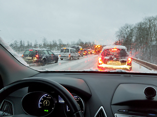 Image showing snowstorm, poor car driving on slick roads