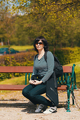 Image showing tired Middle age woman resting on bench