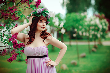 Image showing beautiful girl in purple dress with lilac flowers