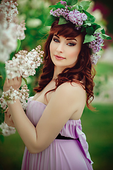 Image showing beautiful girl in purple dress with lilac flowers