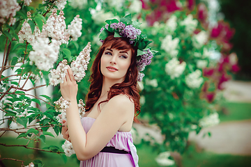 Image showing beautiful girl in purple dress with lilac flowers