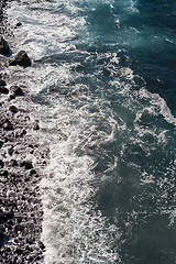 Image showing beautiful view on ocean water and black lava sand