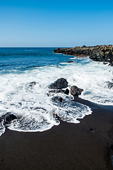 Image showing beautiful view on ocean water and black lava sand