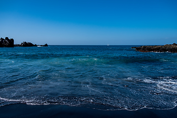 Image showing beautiful view on ocean water and black lava sand