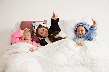 Image showing Children in soft warm pajamas having party colored bright playing at home