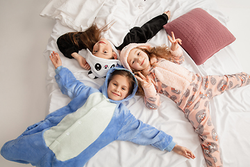 Image showing Children in soft warm pajamas having party colored bright playing at home