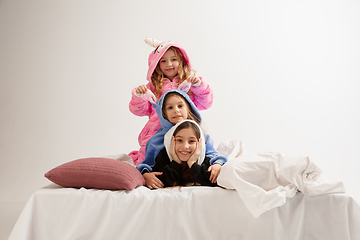 Image showing Children in soft warm pajamas having party colored bright playing at home