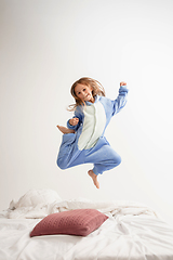 Image showing Little girl in soft warm pajama having party colored bright playing at home