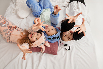 Image showing Children in soft warm pajamas having party colored bright playing at home