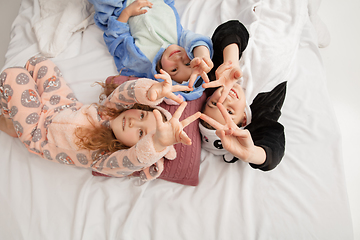 Image showing Children in soft warm pajamas having party colored bright playing at home