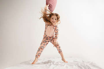 Image showing Little girl in soft warm pajama having party colored bright playing at home