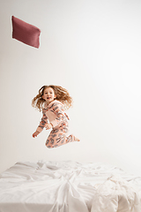 Image showing Little girl in soft warm pajama having party colored bright playing at home