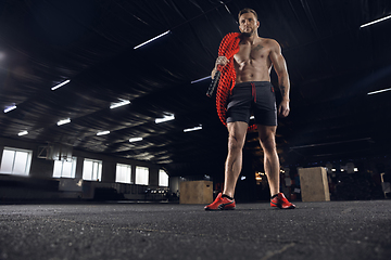 Image showing Young healthy male athlete doing exercises in the gym