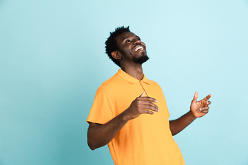 Image showing African man\'s portrait isolated over blue studio background with copyspace