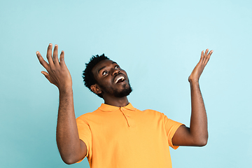 Image showing African man\'s portrait isolated over blue studio background with copyspace