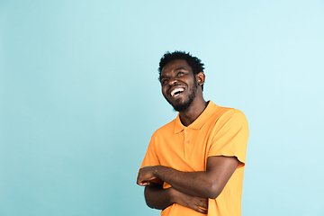 Image showing African man\'s portrait isolated over blue studio background with copyspace