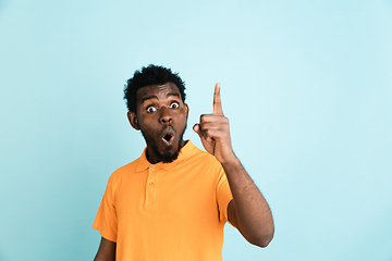 Image showing African man\'s portrait isolated over blue studio background with copyspace