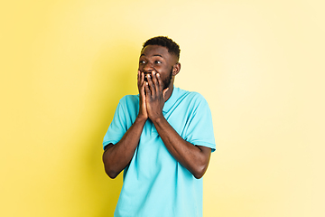 Image showing Portrait of young African man isolated over yellow studio background with copyspace.