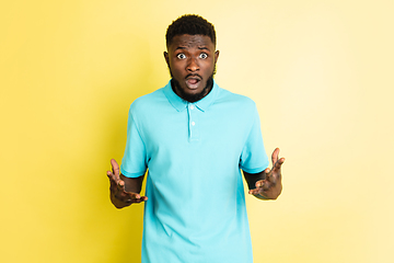 Image showing Portrait of young African man isolated over yellow studio background with copyspace.