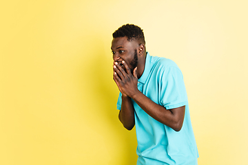 Image showing Portrait of young African man isolated over yellow studio background with copyspace.