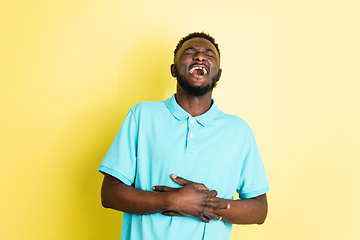 Image showing Portrait of young African man isolated over yellow studio background with copyspace.