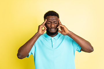 Image showing Portrait of young African man isolated over yellow studio background with copyspace.