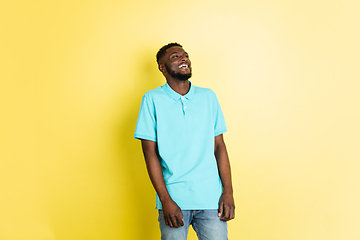 Image showing Portrait of young African man isolated over yellow studio background with copyspace.