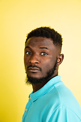 Image showing Portrait of young African man isolated over yellow studio background with copyspace.