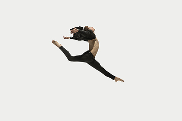 Image showing Man in casual style clothes jumping and dancing isolated on white background. Art, motion, action, flexibility, inspiration concept. Flexible caucasian ballet dancer.