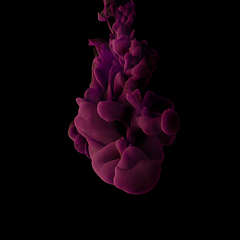 Image showing Explosion of colored, fluid and neoned liquids on black studio background with copyspace