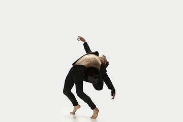 Image showing Man in casual style clothes jumping and dancing isolated on white background. Art, motion, action, flexibility, inspiration concept. Flexible caucasian ballet dancer.