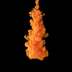 Image showing Explosion of colored, fluid and neoned liquids on black studio background with copyspace