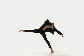 Image showing Man in casual style clothes jumping and dancing isolated on white background. Art, motion, action, flexibility, inspiration concept. Flexible caucasian ballet dancer.