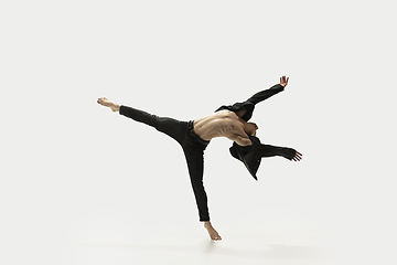 Image showing Man in casual style clothes jumping and dancing isolated on white background. Art, motion, action, flexibility, inspiration concept. Flexible caucasian ballet dancer.