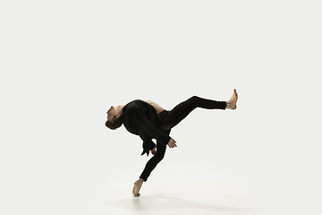 Image showing Man in casual style clothes jumping and dancing isolated on white background. Art, motion, action, flexibility, inspiration concept. Flexible caucasian ballet dancer.