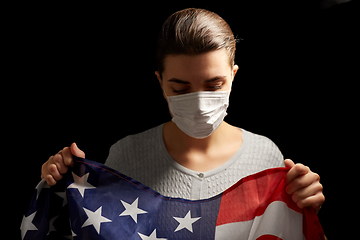 Image showing sick woman in face mask holding flag of america