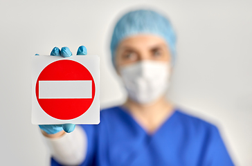 Image showing doctor or nurse in face mask showing stop sign