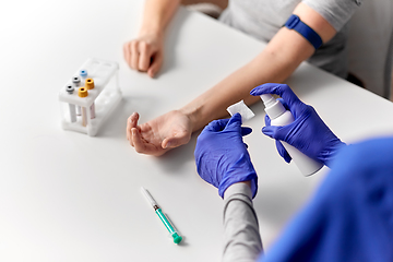 Image showing doctor and patient preparing for blood test