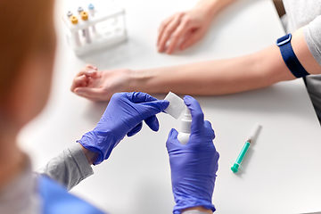 Image showing doctor and patient preparing for blood test