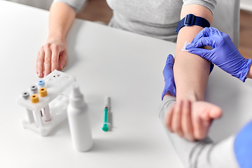 Image showing doctor and patient preparing for blood test