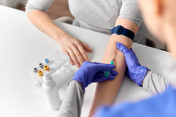 Image showing doctor taking blood for test from patient's hand