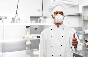 Image showing chef in respirator showing thumbs up at kitchen