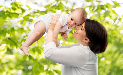 Image showing happy middle-aged mother with little baby daughter