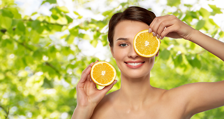 Image showing beautiful woman making eye mask of orange slices