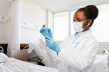 Image showing african american doctor with syringe at hospital