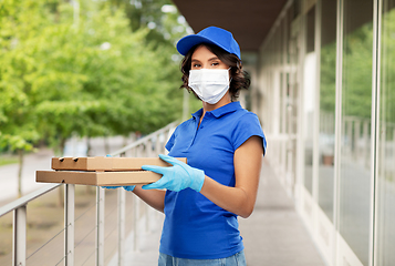 Image showing delivery woman in face mask with pizza boxes