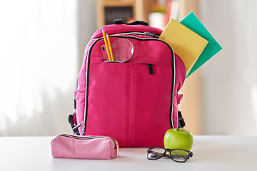 Image showing pink backpack, apple and school supplies on table