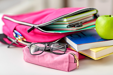 Image showing backpack, apple and school supplies on table