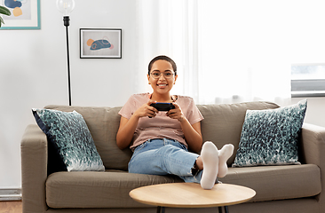 Image showing african american woman with gamepad playing game