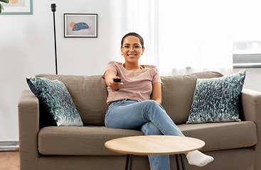 Image showing happy african american woman watching tv at home